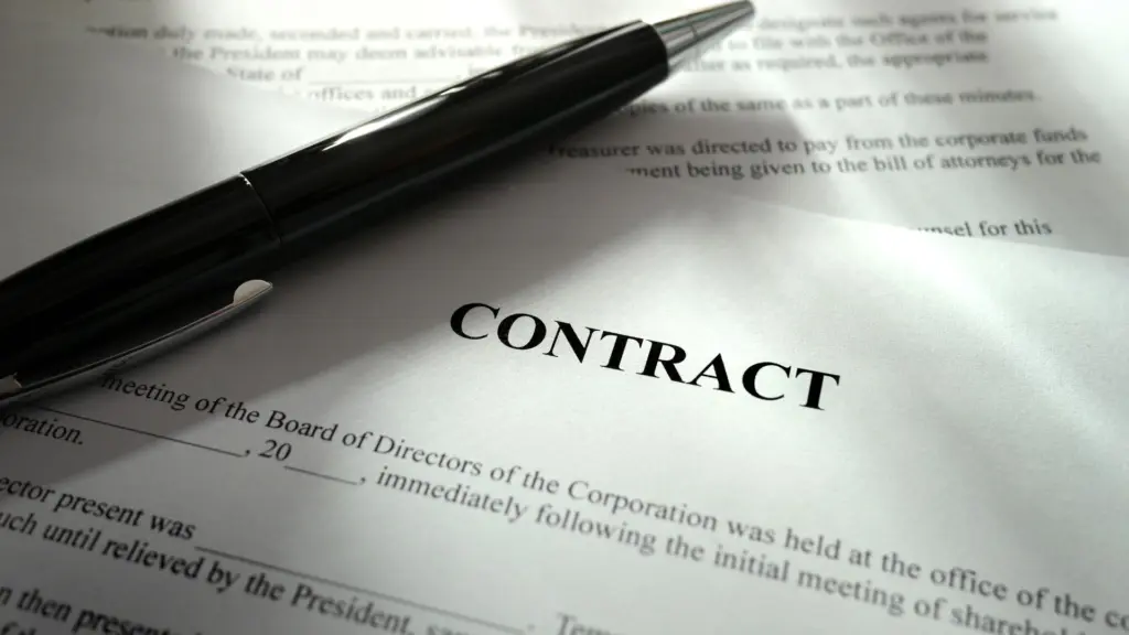 A contract with a pen on top.