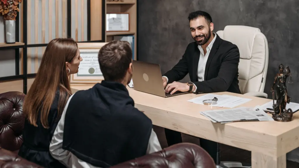 A lawyer talking to his clients. 