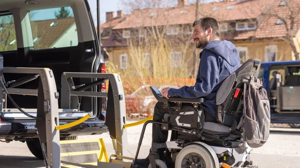 A man in a wheelchair getting in a van. 