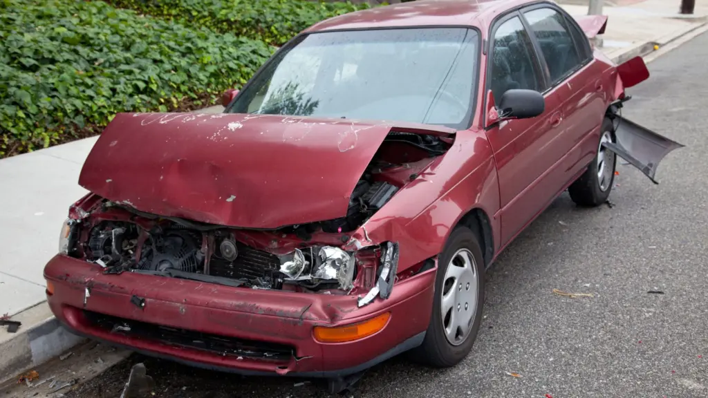 A damaged red car. 