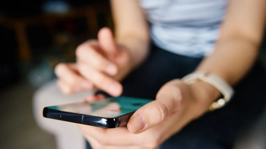 A person on their phone using social media. 