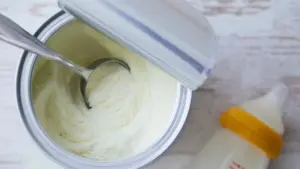 An overview shot of an open container of baby formula.