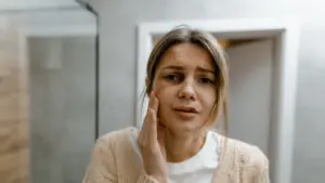 A closeup of a woman with a bruised face. 
