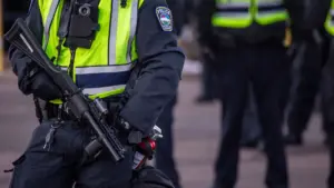 A closeup of an officer with a tear gas weapon. 