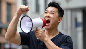 A man shouting on a megaphone.